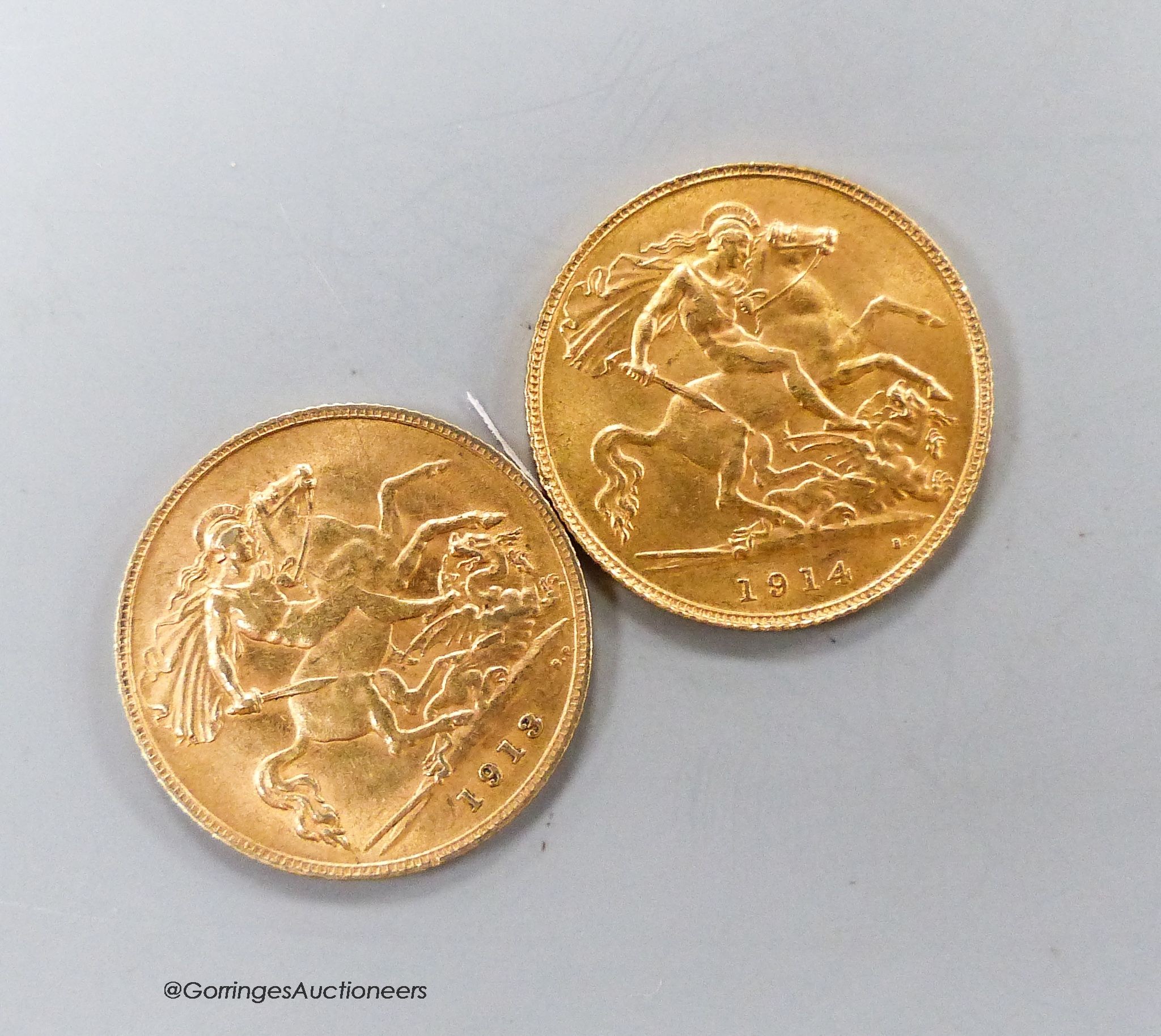 Two George V gold half sovereigns, 1913 & 1914 and an Edwardian silver sovereign case.